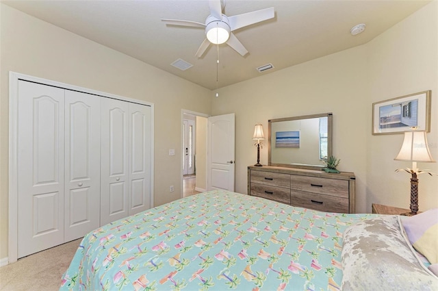 carpeted bedroom with ceiling fan and a closet