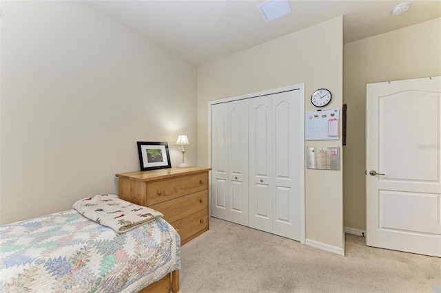 bedroom with light carpet and a closet