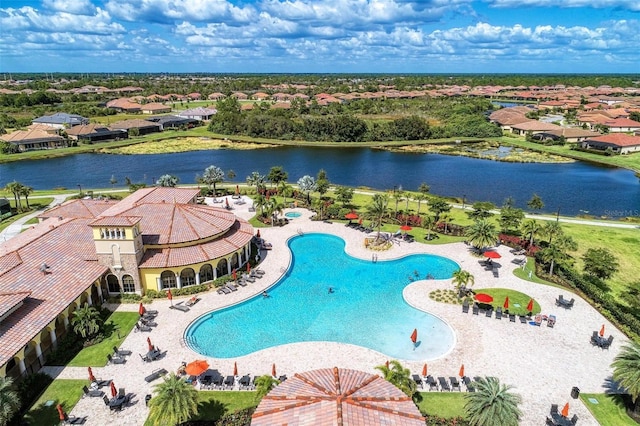 view of pool with a patio and a water view