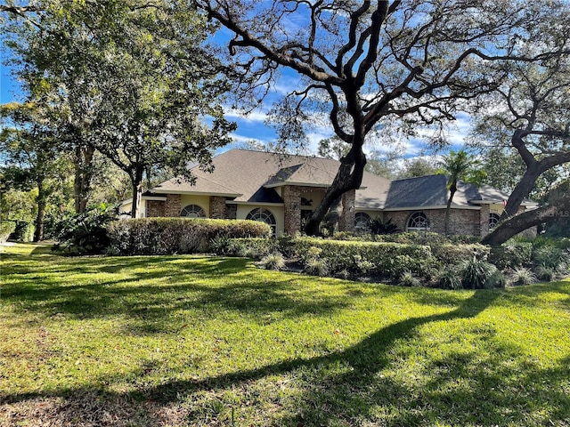 ranch-style house with a front lawn