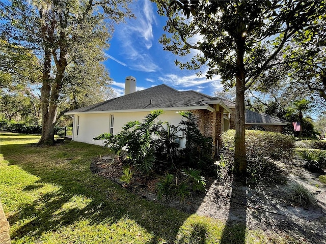view of side of home featuring a yard