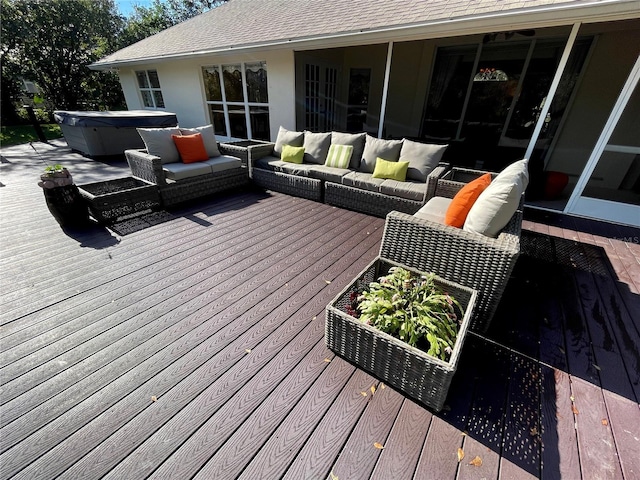deck featuring a hot tub and outdoor lounge area