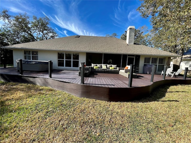 back of house with a wooden deck, a yard, a hot tub, and outdoor lounge area