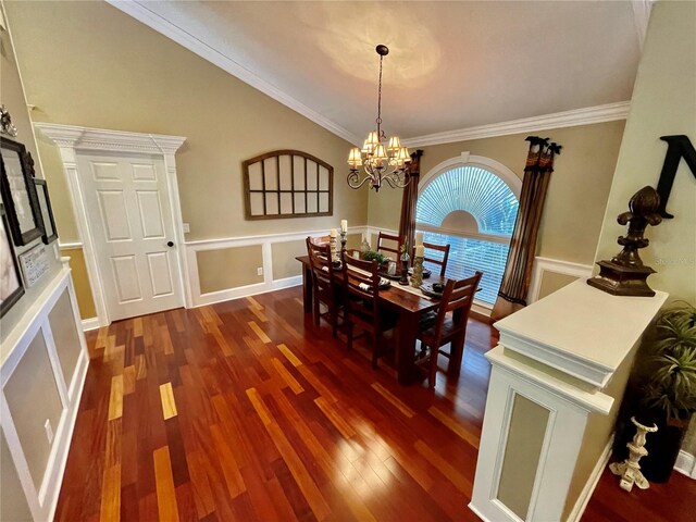 dining space featuring an inviting chandelier, ornamental molding, and dark wood-type flooring