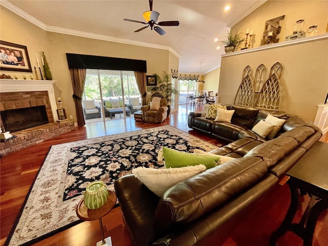 living room featuring ornamental molding, lofted ceiling, dark hardwood / wood-style floors, and a brick fireplace