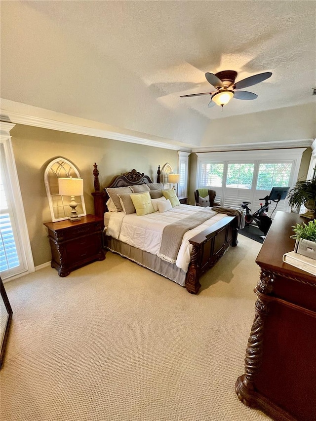 carpeted bedroom with multiple windows, ceiling fan, vaulted ceiling, and a textured ceiling