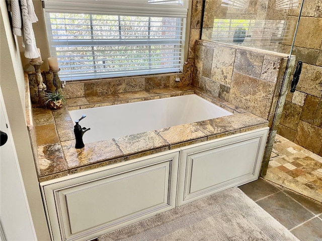 bathroom featuring separate shower and tub