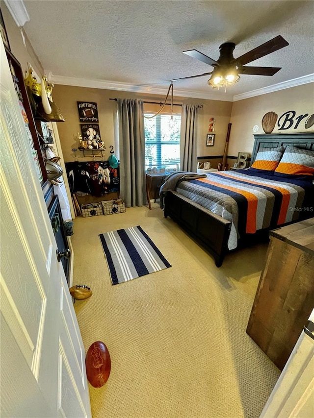 bedroom featuring crown molding, carpet, a textured ceiling, and ceiling fan
