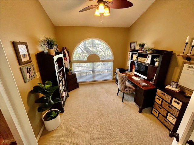 carpeted office space with lofted ceiling and ceiling fan