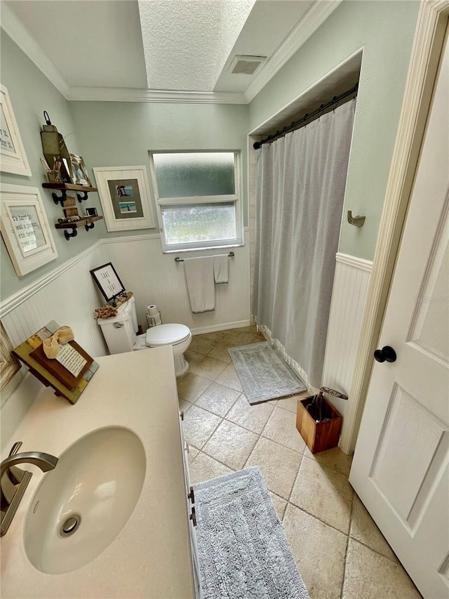 bathroom with sink, crown molding, tile patterned flooring, a textured ceiling, and toilet