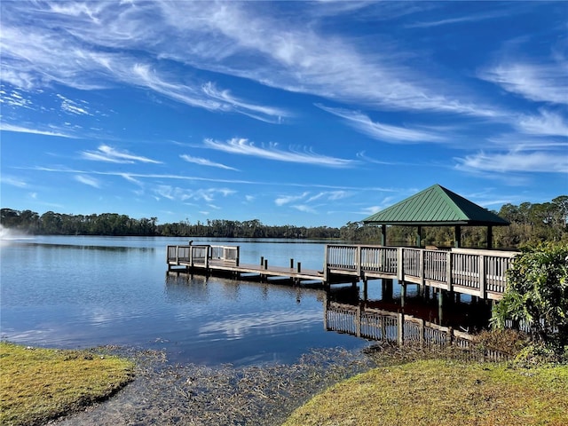 view of dock with a gazebo and a water view