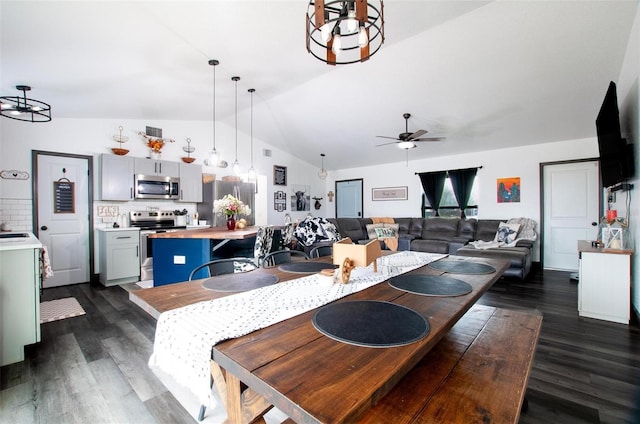 dining space featuring lofted ceiling, sink, dark wood-type flooring, and ceiling fan