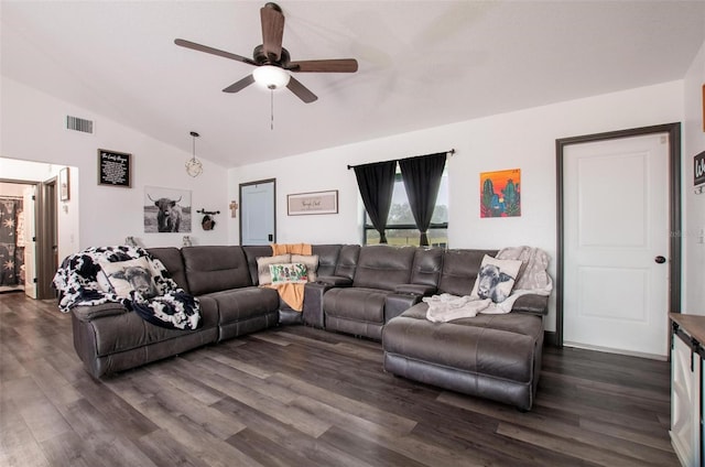 living room with dark wood-type flooring, ceiling fan, and vaulted ceiling