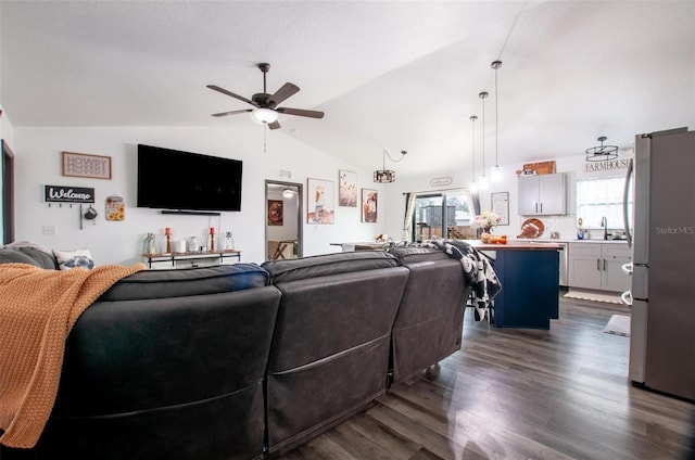 living room featuring dark wood-type flooring, ceiling fan, lofted ceiling, and sink