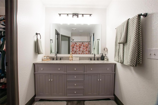 bathroom with walk in shower and vanity