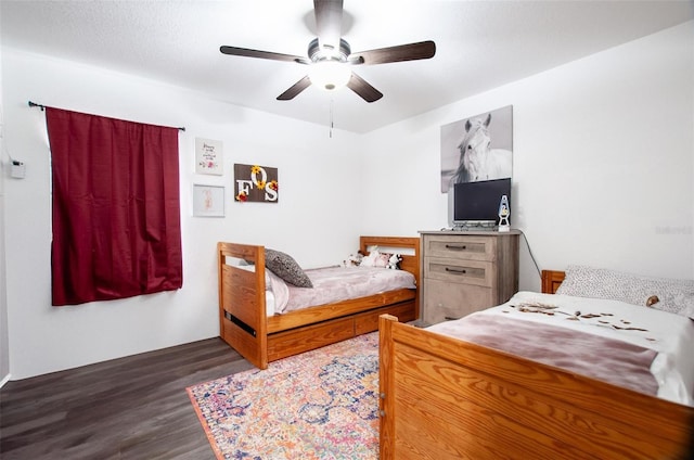 bedroom featuring dark hardwood / wood-style floors and ceiling fan