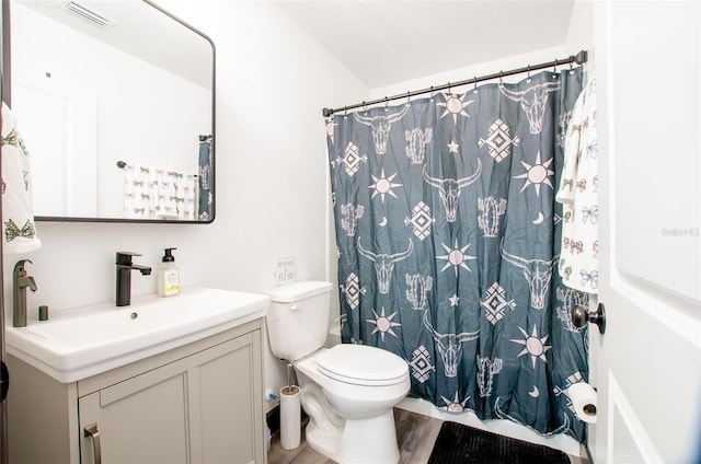 bathroom featuring a shower with shower curtain, vanity, toilet, and hardwood / wood-style floors