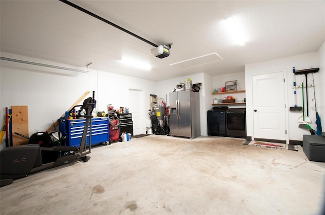 garage featuring a garage door opener, washer and dryer, and stainless steel fridge with ice dispenser