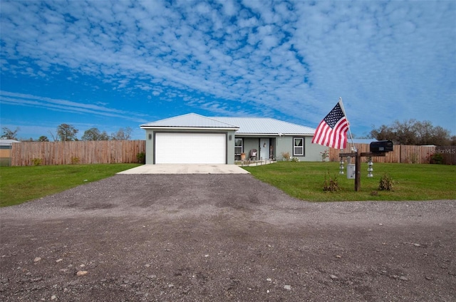 single story home featuring a garage and a front lawn