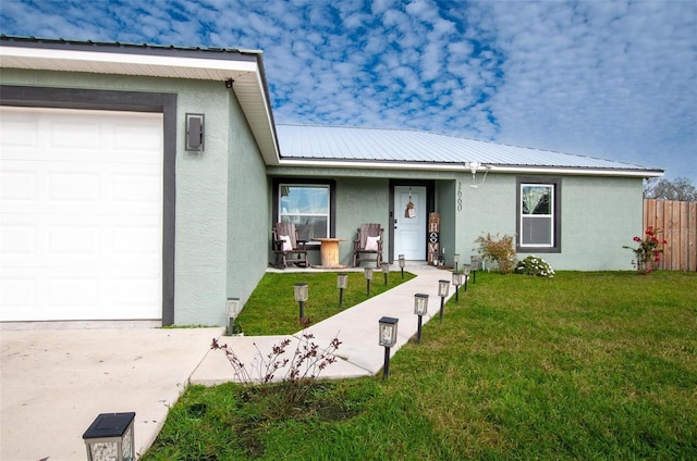 ranch-style house with a garage and a front lawn