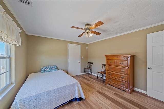 bedroom with ceiling fan, ornamental molding, multiple windows, and light hardwood / wood-style flooring