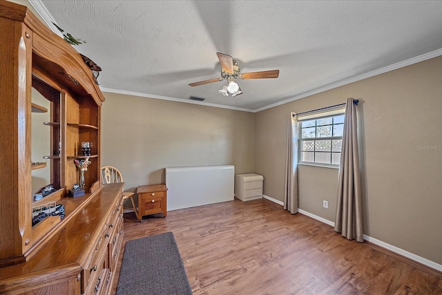 unfurnished office with hardwood / wood-style flooring, ceiling fan, and crown molding