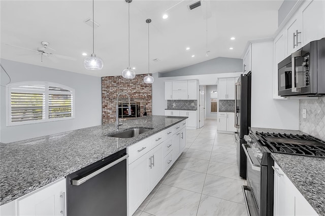 kitchen featuring pendant lighting, white cabinetry, dark stone countertops, black appliances, and vaulted ceiling