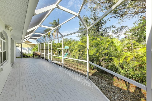 unfurnished sunroom featuring lofted ceiling