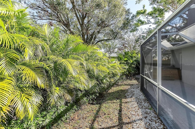 view of yard with glass enclosure