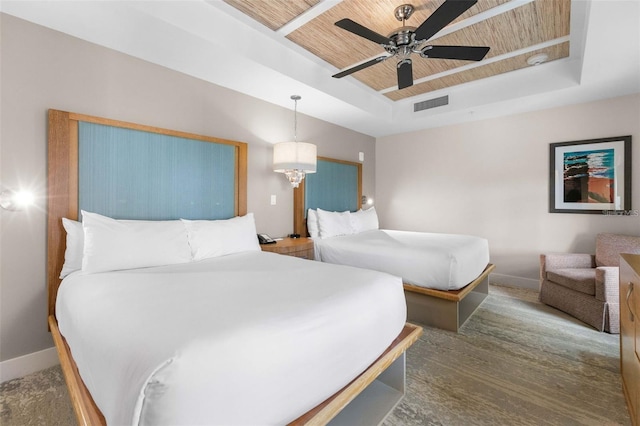 bedroom featuring a raised ceiling, ceiling fan with notable chandelier, and wooden ceiling