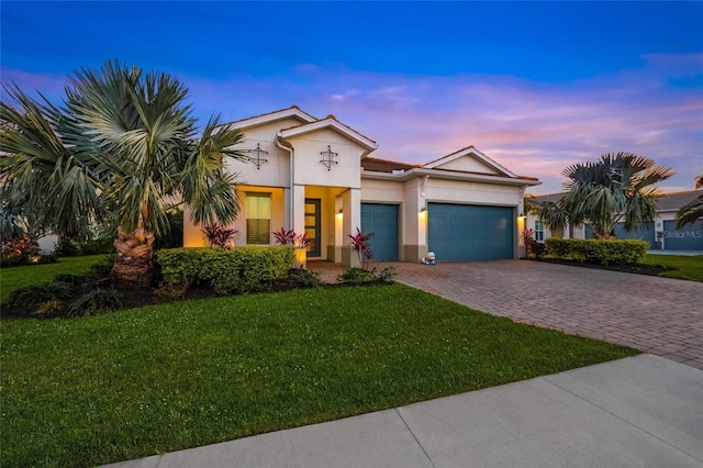 view of front of house with a yard and a garage