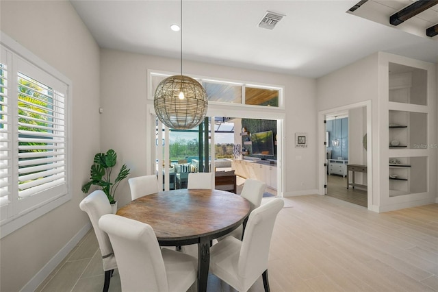 dining room featuring a wealth of natural light and light wood-type flooring