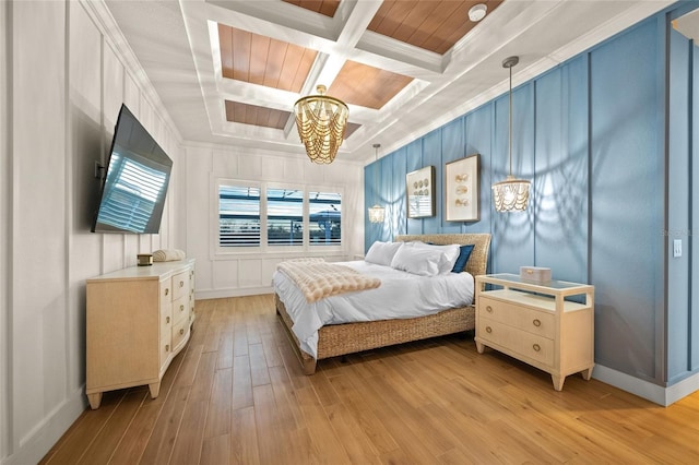 bedroom featuring an inviting chandelier, coffered ceiling, ornamental molding, light hardwood / wood-style floors, and beamed ceiling