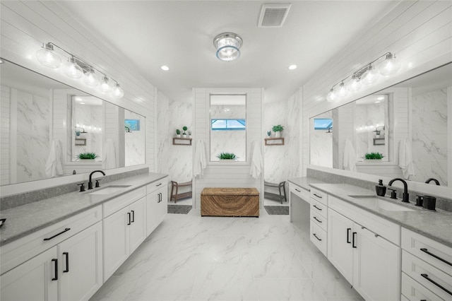 bathroom with vanity and tile walls