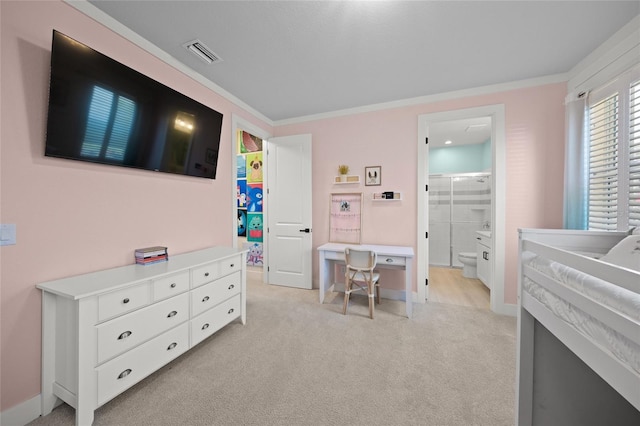 bedroom featuring crown molding, light colored carpet, and ensuite bath