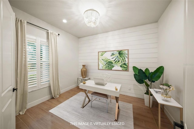 office area with hardwood / wood-style flooring and an inviting chandelier