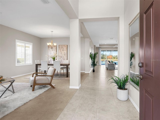 tiled entryway with an inviting chandelier and a wealth of natural light