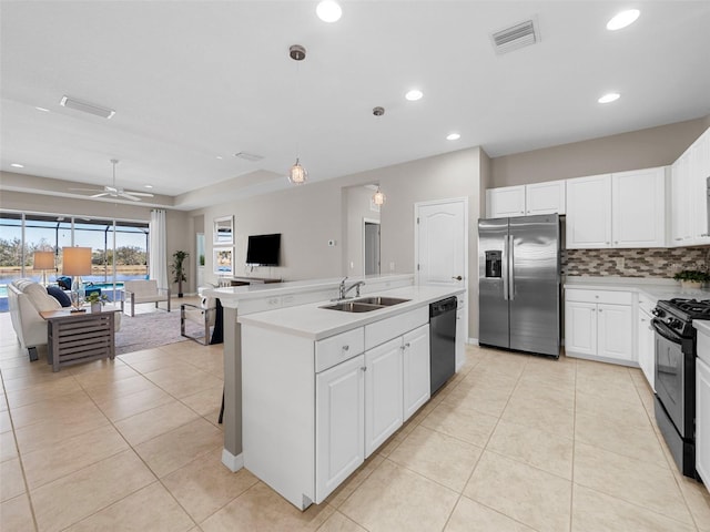 kitchen with sink, white cabinetry, black range with gas stovetop, stainless steel fridge, and dishwashing machine