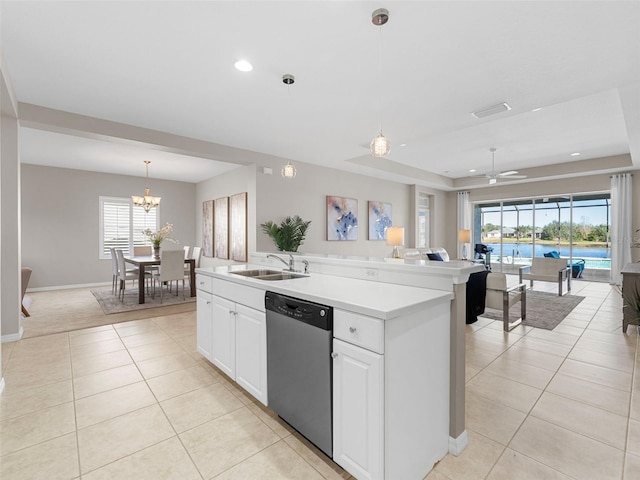 kitchen with hanging light fixtures, light tile patterned floors, a center island with sink, dishwasher, and white cabinets