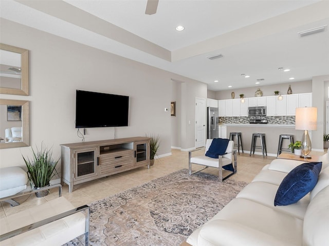 living room with ceiling fan and light tile patterned floors