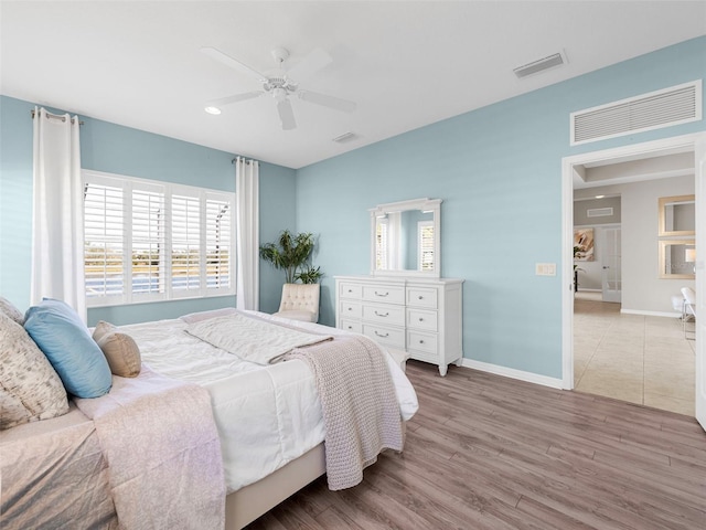 bedroom featuring ceiling fan and light hardwood / wood-style floors