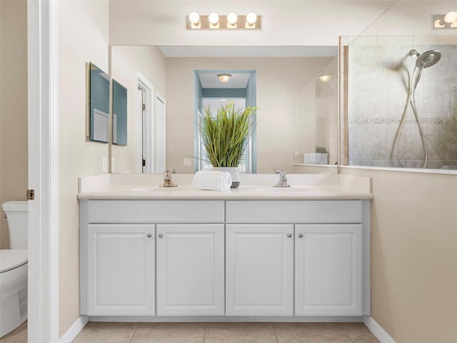 bathroom featuring tiled shower, vanity, toilet, and tile patterned floors