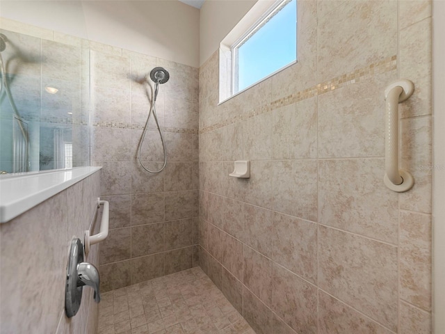 bathroom with tiled shower