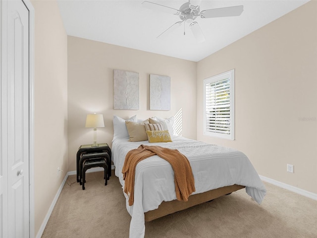 bedroom featuring ceiling fan and light colored carpet