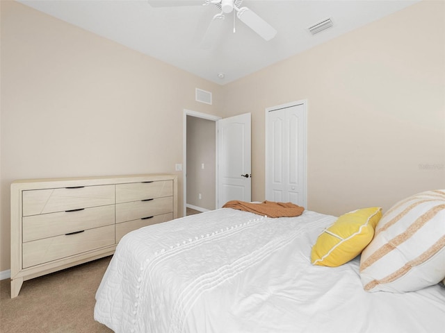 bedroom with light colored carpet, a closet, and ceiling fan