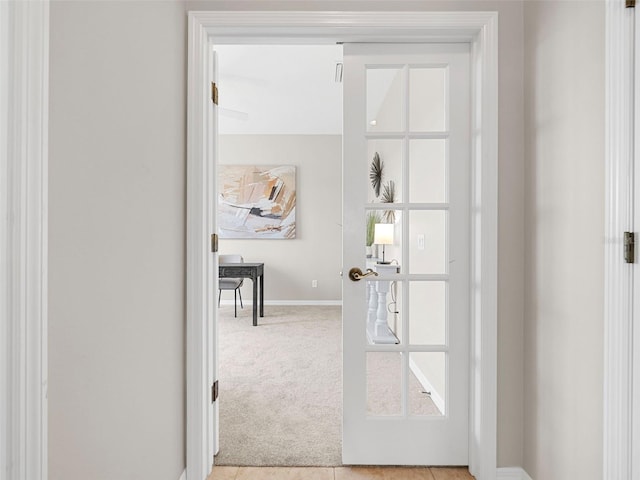 interior space featuring french doors and light colored carpet