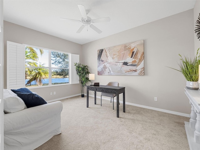 office area featuring light carpet and ceiling fan