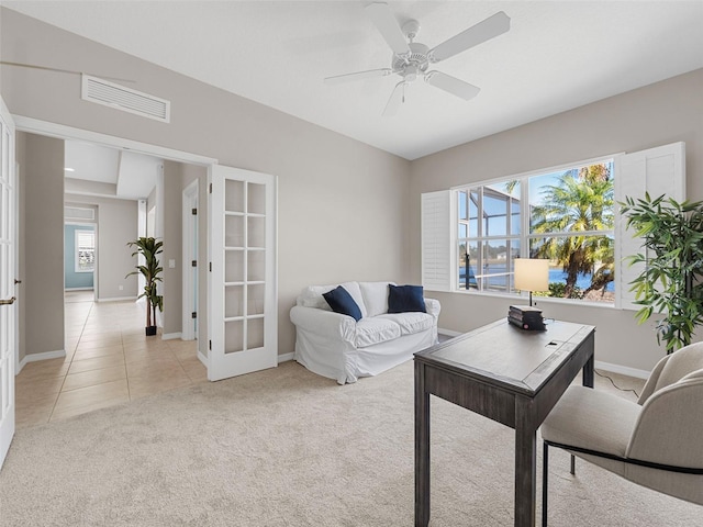 living room featuring french doors, ceiling fan, and light carpet