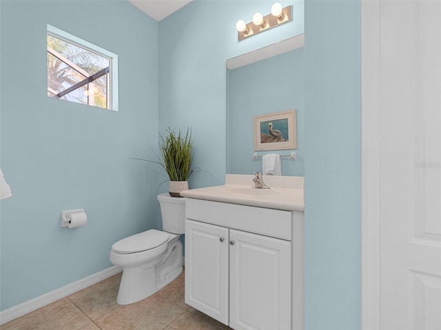 bathroom featuring vanity, tile patterned floors, and toilet