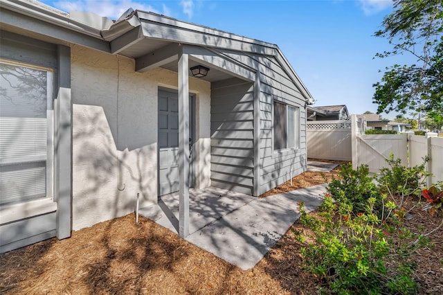 view of exterior entry featuring a patio